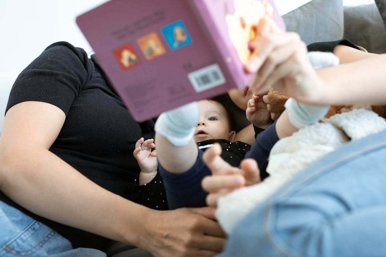 Blog A baby and family reading together, promoting love and education. Cozy indoors setting.